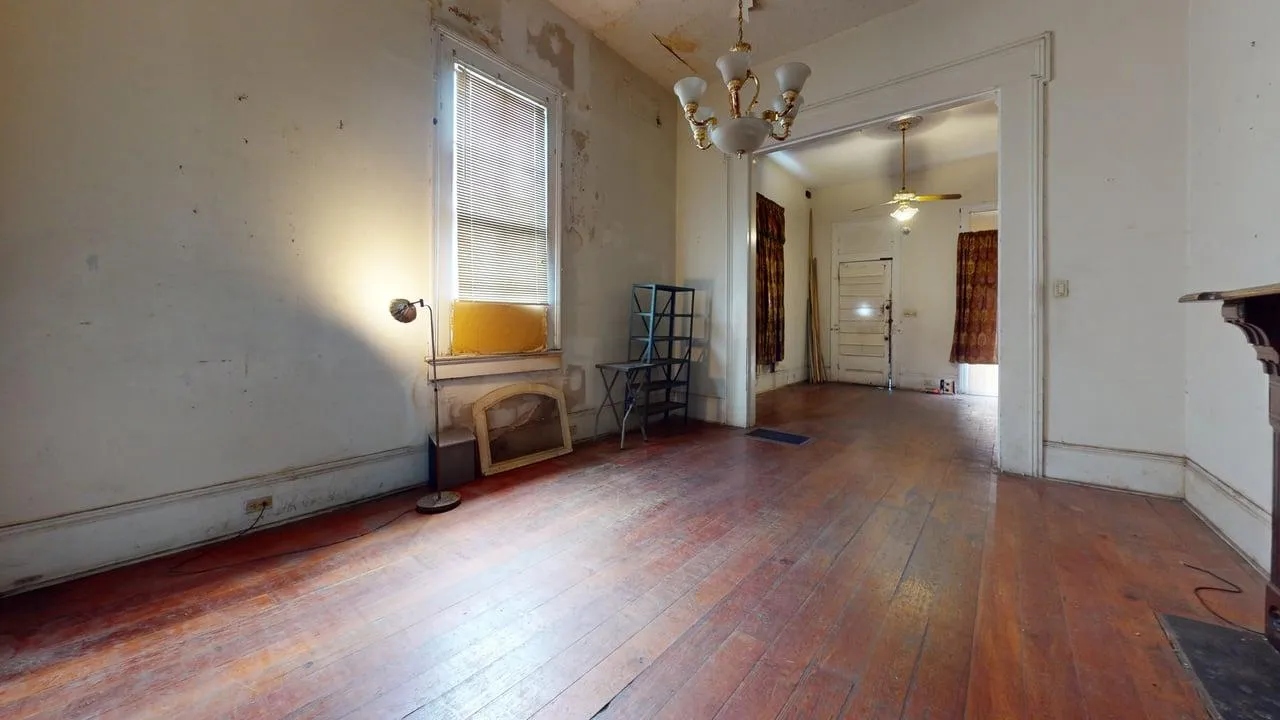 Living area before — hoarding conditions, contamination, deteriorated finishes